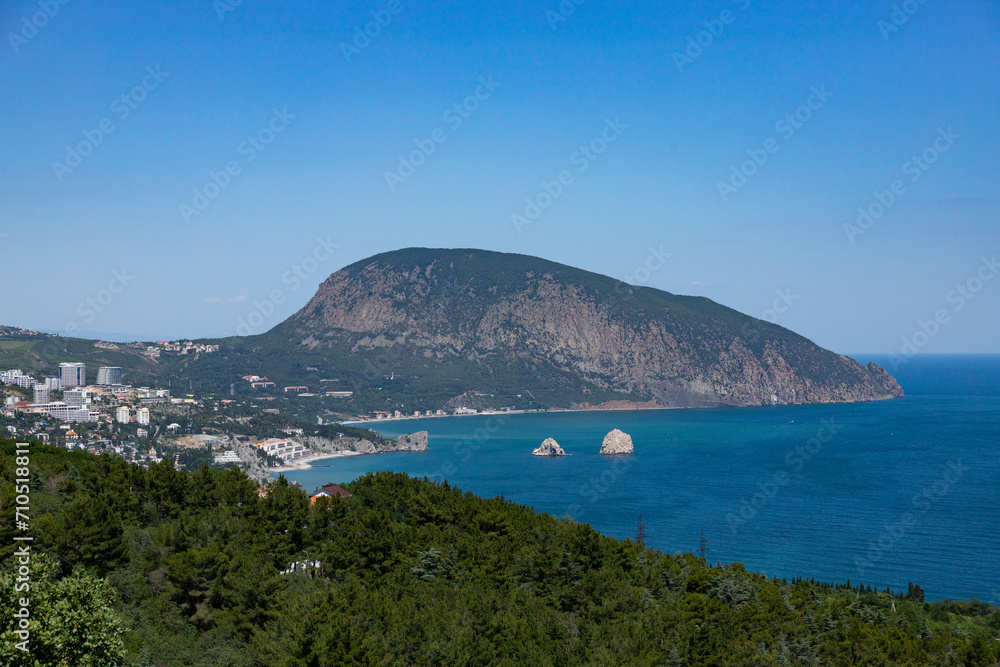 Seascape with a lonely mountain and houses at the foot of the mountains. Black Sea.