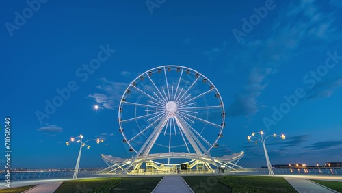 Ferris wheel silhouette at sunset beautiful clouds in the sky. Big round metal structure tall man made construction used for observation and amusement rides timelapse hyperlapse 4K Baku Azerbaijan