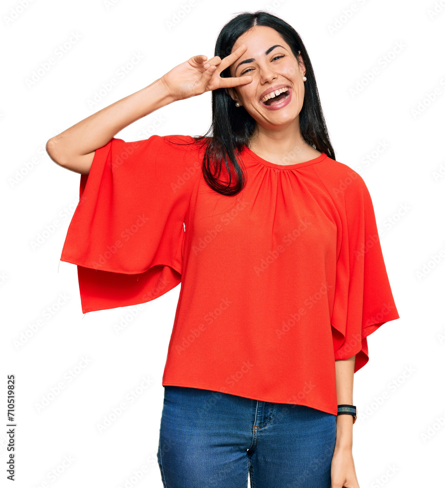 Beautiful young woman wearing casual clothes doing peace symbol with fingers over face, smiling cheerful showing victory Beautiful young woman wearing casual clothes doing peace symbol with fingers over face, smiling cheerful showing victory