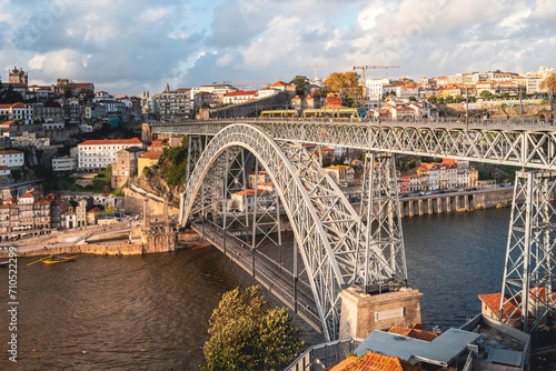 Panoramic view of the city of Oporto during sunset. Porto skyline. Magnificent sunset over downtown Porto and the Douro river, Portugal. The Dom Luis I bridge is a popular tourist spot. © ikuday