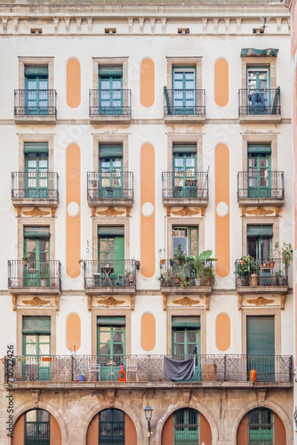 Facade of a typical Barcelona building. Residential building with balconies and windows. Colorful apartment buildings. windows and balconies. Buildings architecture in Europe