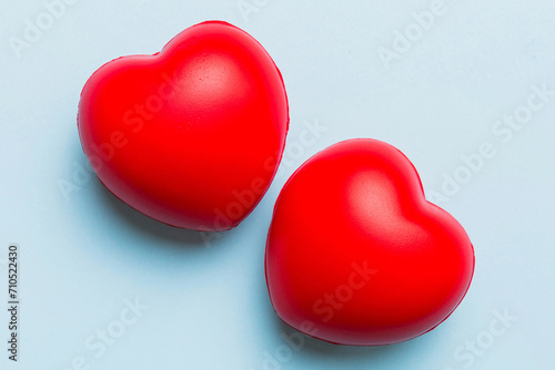 red heart shape on colored background. minimal concept top view with copy space © sosiukin