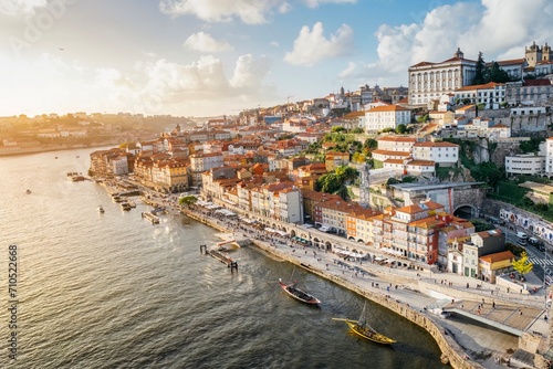 Panoramic view of the city of Oporto during sunset. Porto skyline. Magnificent sunset over downtown Porto and the Douro river, Portugal. The Dom Luis I bridge is a popular tourist spot. photo
