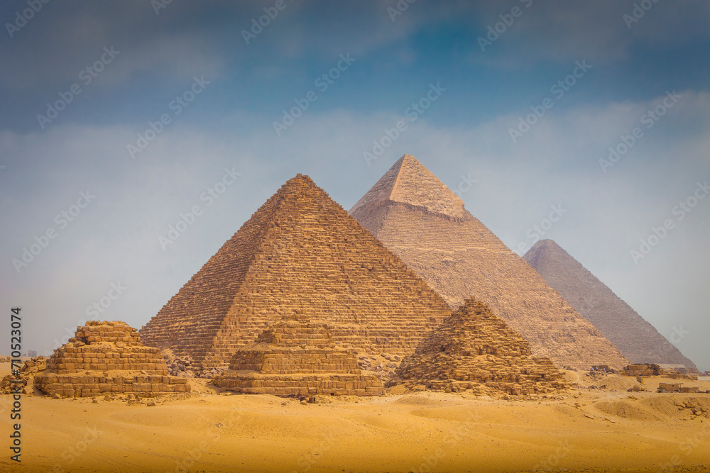 View of The Giza Necropolis, Famed archaeological site featuring the Great Pyramids, the Great Sphinx and The Great Pyramid of Giza in the desert of Giza, Cairo, Egypt. View of The Giza Necropolis, Famed archaeological site featuring the Great Pyramids, the Great Sphinx and The Great Pyramid of Giza in the desert of Giza, Cairo, Egypt.