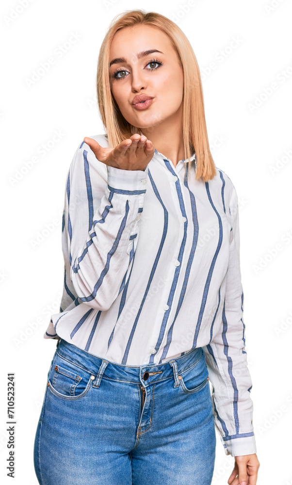 Beautiful caucasian woman wearing casual clothes looking at the camera blowing a kiss with hand on air being lovely and sexy. love expression. Beautiful caucasian woman wearing casual clothes looking at the camera blowing a kiss with hand on air being lovely and sexy. love expression.
