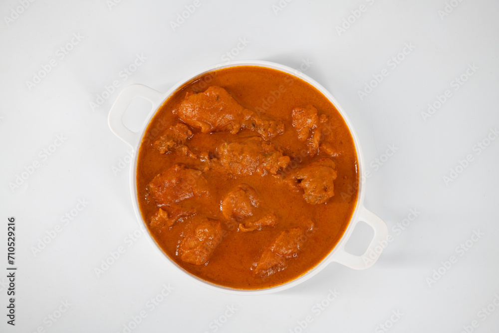 Tasty butter chicken curry dish from Indian cuisine. Tasty butter chicken curry, Murg Makhanwala or masala. Butter chicken tikka masala served with roti / Paratha and plain rice along with onion salad Tasty butter chicken curry dish from Indian cuisine. Tasty butter chicken curry, Murg Makhanwala or masala. Butter chicken tikka masala served with roti / Paratha and plain rice along with onion salad