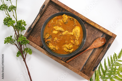 Chicken curry or masala or country chicken kuzhambu Tamilnadu style , chicken curry using fried coconut oil in traditional way and served in a mud pot. Main dish for rice, chapati and paratha. photo