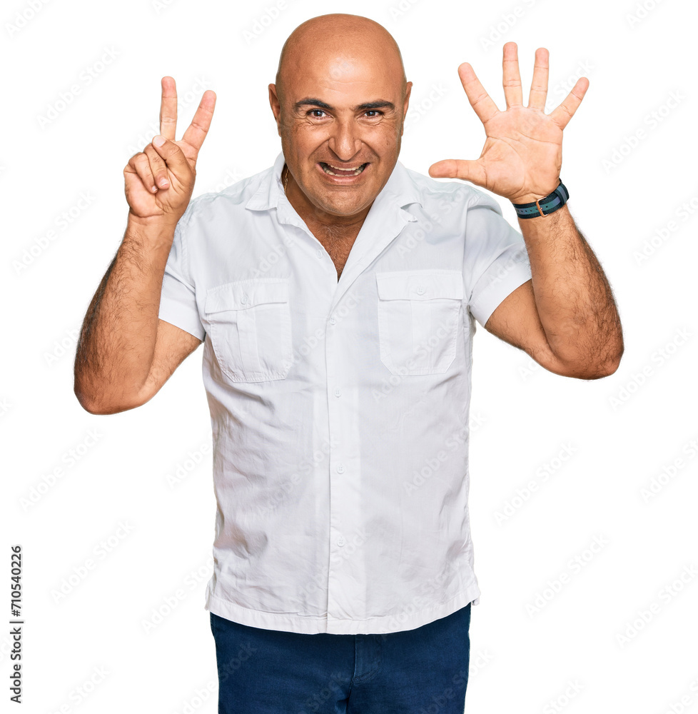 Naklejka premium Mature middle east man with mustache wearing casual white shirt showing and pointing up with fingers number seven while smiling confident and happy.