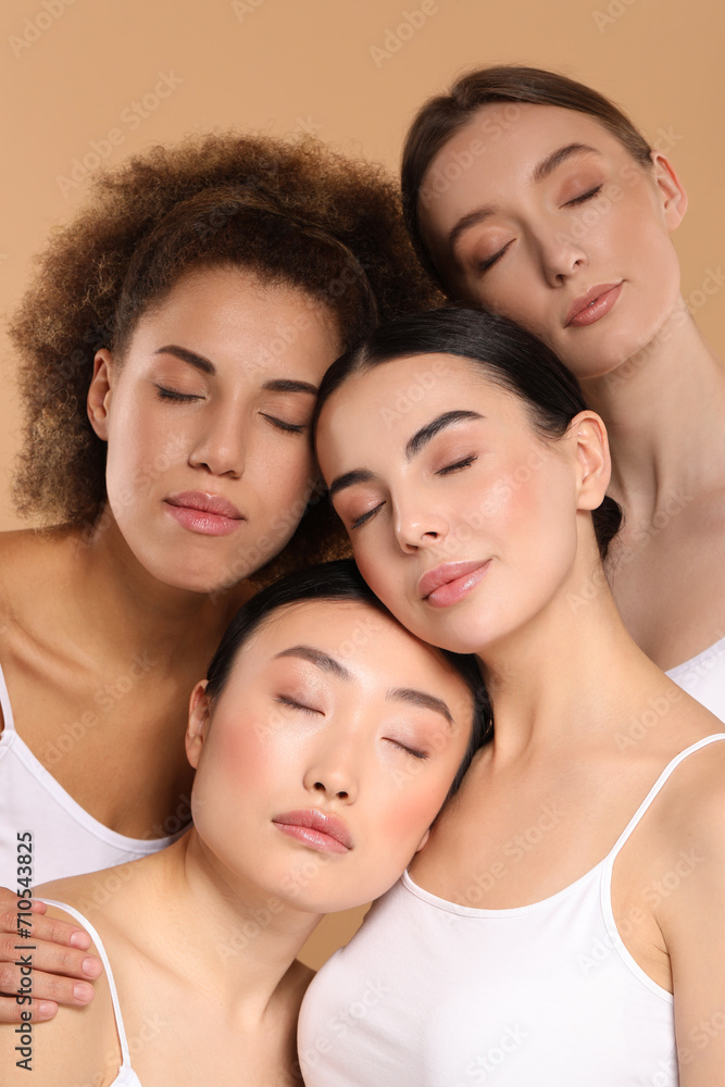 Fototapeta premium Beautiful young women with healthy skin on beige background