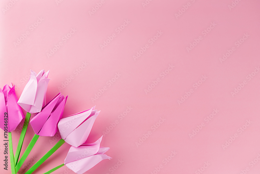 Tulips made of colored paper on a pink background, handmade, copy space. Mother's day, women's day concept.
