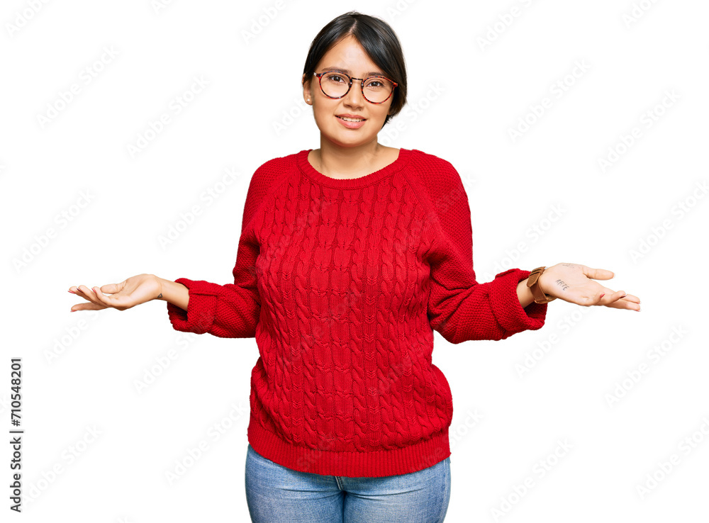 Young beautiful hispanic woman with short hair wearing casual sweater and glasses clueless and confused with open arms, no idea concept. Young beautiful hispanic woman with short hair wearing casual sweater and glasses clueless and confused with open arms, no idea concept.