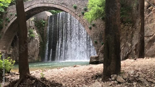 The old stone, arched bridge, between two waterfalls in Palaiokaria, Trikala prefecture, Thessaly, Greece. photo