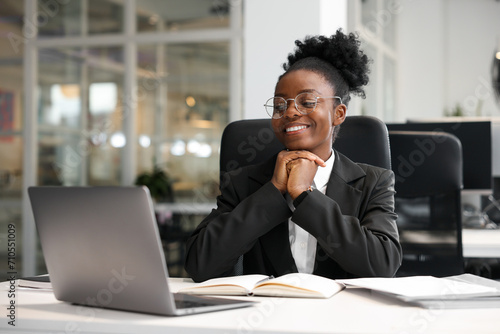 Happy woman working at table in office. Lawyer, businesswoman, accountant or manager photo