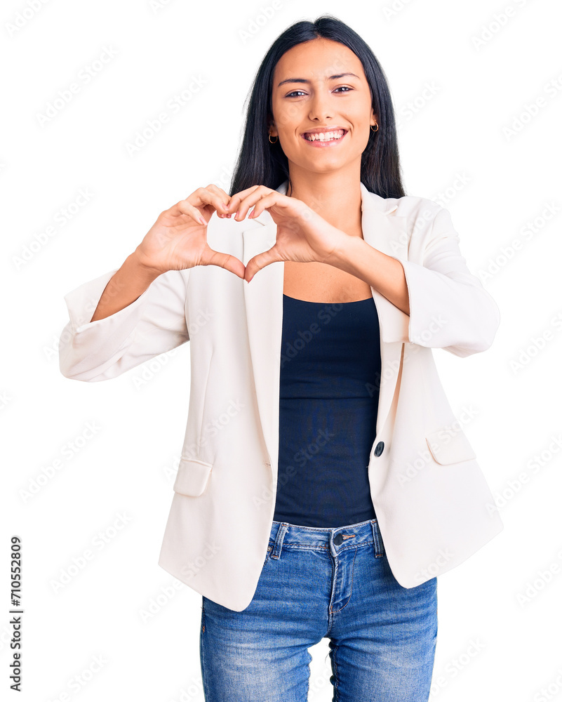 Young beautiful latin girl wearing business clothes smiling in love showing heart symbol and shape with hands. romantic concept. Young beautiful latin girl wearing business clothes smiling in love showing heart symbol and shape with hands. romantic concept.