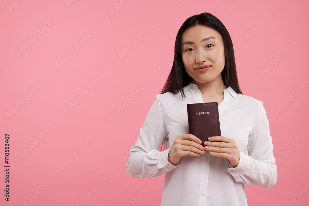 Immigration. Woman with passport on pink background, space for text Immigration. Woman with passport on pink background, space for text