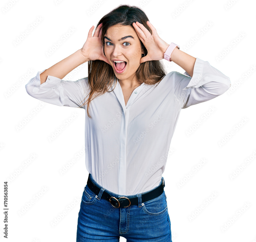 Young caucasian girl wearing casual white shirt smiling cheerful playing peek a boo with hands showing face. surprised and exited