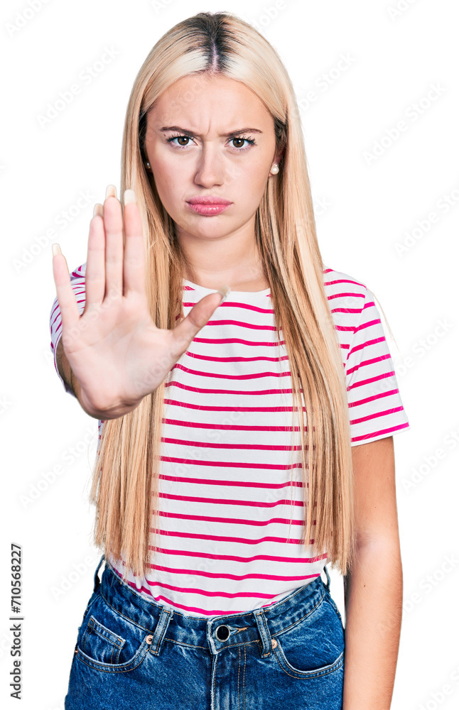 Beautiful blonde woman wearing casual striped t shirt doing stop sing with palm of the hand. warning expression with negative and serious gesture on the face. Beautiful blonde woman wearing casual striped t shirt doing stop sing with palm of the hand. warning expression with negative and serious gesture on the face.