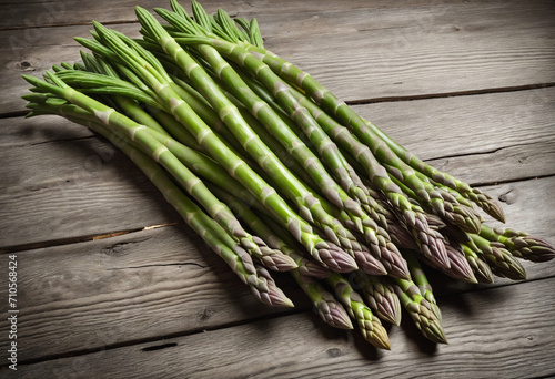 Farm-fresh asparagus on rustic wooden surface, blurred background.