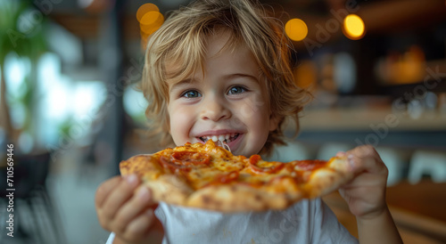 Little boy holding a piece of pizza. A young boy is happily devouring a slice of pizza  savoring every bite with a delightful smile.
