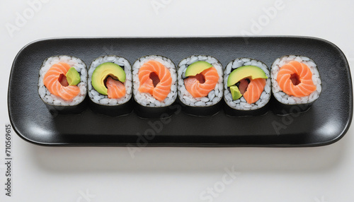 Fresh sushi rolls with salmon, avocado, and black sesame seeds - Japanese uramaki or California roll on white background.
