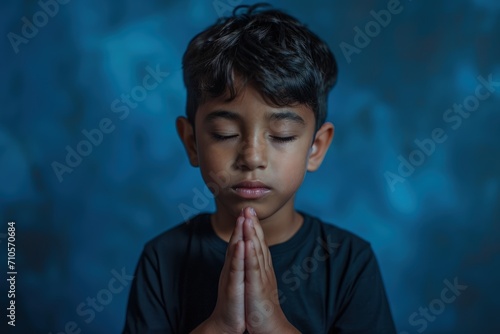 Young Boy in Black Shirt Praying photo