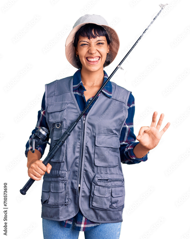 Young brunette woman with short hair wearing fisherman equipment doing ok sign with fingers, smiling friendly gesturing excellent symbol Young brunette woman with short hair wearing fisherman equipment doing ok sign with fingers, smiling friendly gesturing excellent symbol