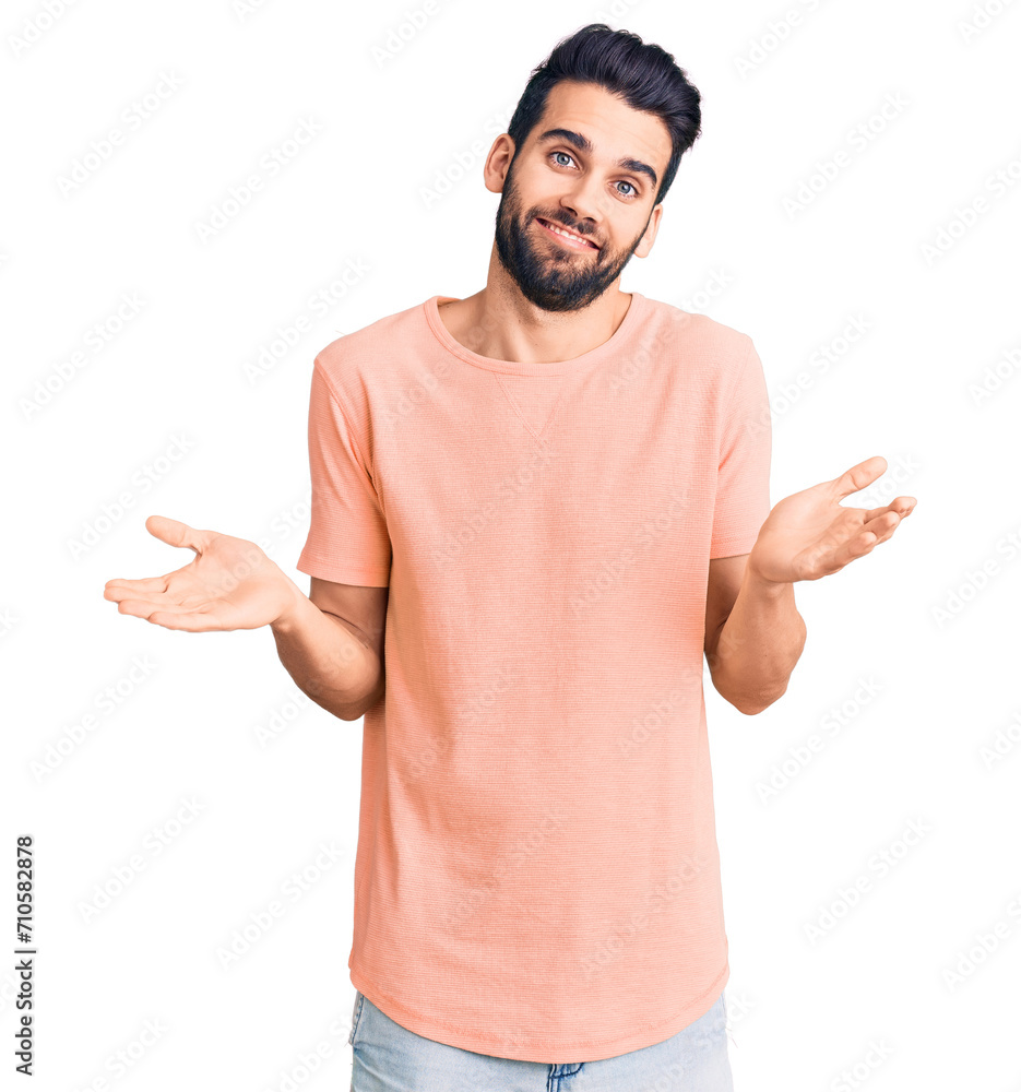 Young handsome man with beard wearing casual t-shirt clueless and confused expression with arms and hands raised. doubt concept. Young handsome man with beard wearing casual t-shirt clueless and confused expression with arms and hands raised. doubt concept.