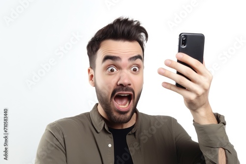 shot of a man holding up his mobile phone against a white background