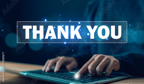 businessman using a laptop and showing the message thank you on a display screen. concept of thank you business, appreciation and gratitude, congratulations, presentation from technology digital photo