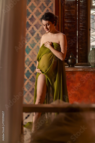 pregnant woman wrapped in green cloth
