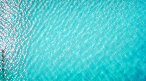 Turquoise bright water surface with sun refection in swimming pool. Relaxation background	