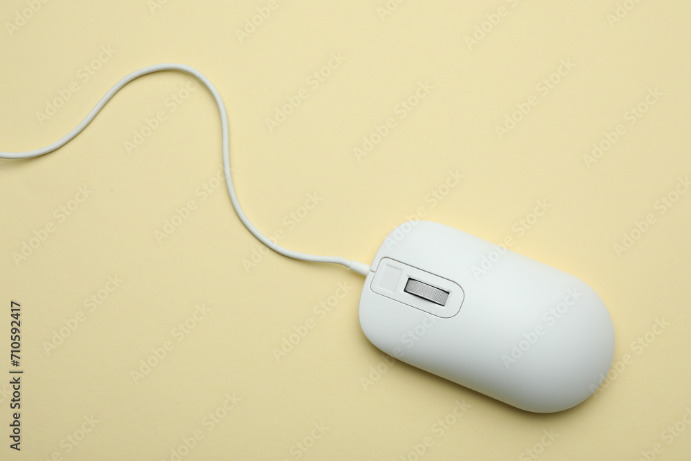 Wired computer mouse on yellow background, top view Wired computer mouse on yellow background, top view