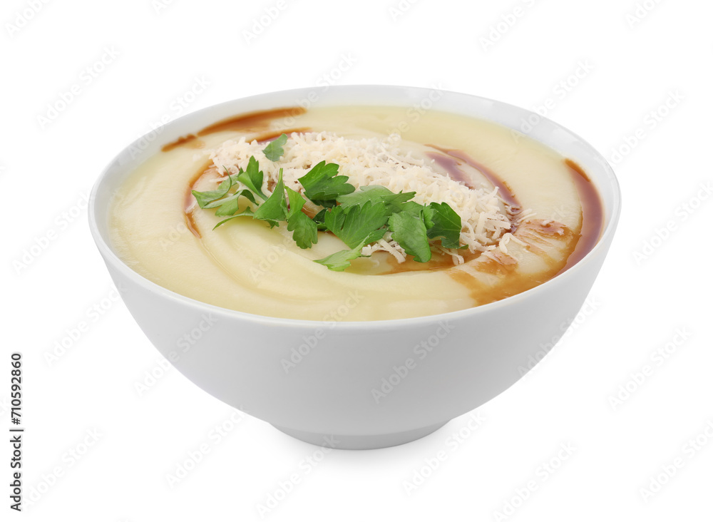 Delicious cream soup with parmesan cheese, soy sauce and parsley in bowl isolated on white