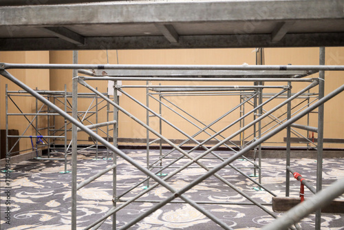 Scaffolding construction. Steeplejacks on a scaffold in the room.
