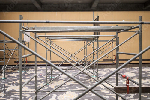 Scaffolding construction. Steeplejacks on a scaffold in the room.