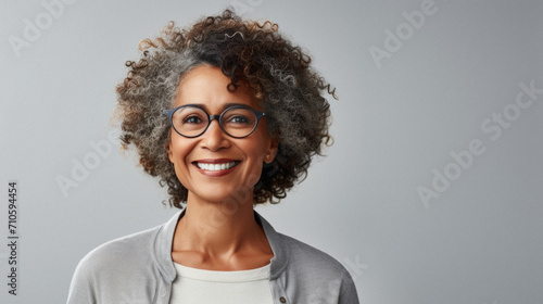 Young african american girl with curly hair wearing casual clothes winking looking at the camera with sexy expression, cheerful and happy face. photo