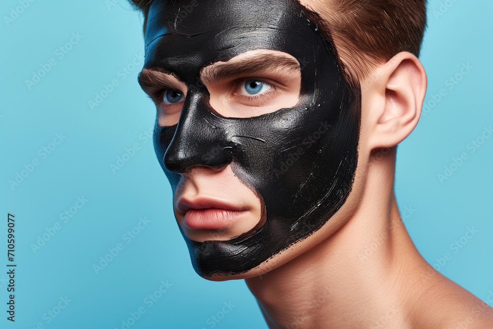 Spa Day: Young Man Relaxing with a Charcoal Facial Mask Spa Day: Young Man Relaxing with a Charcoal Facial Mask
