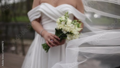 the bride holds a wedding bouquet in her hands