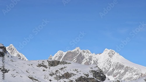 Piz Roseg, Piz Scerscen and Piz Bernina with moving clouds in the sky photo