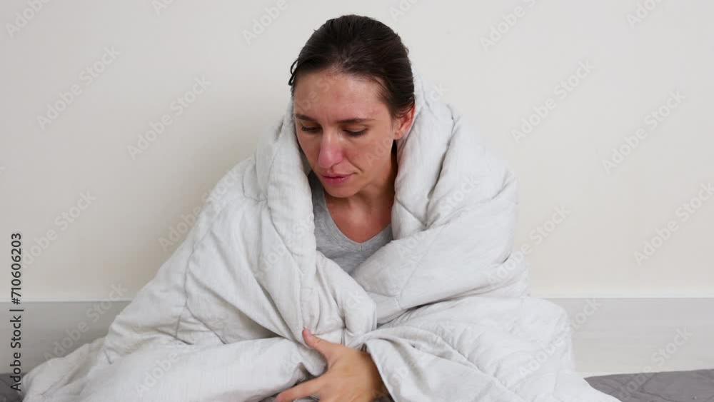 millennial woman wrapped in blanket sitting on bed with coffee or tea cup and pills bottle.girl lying on pillow with cover on head.smiling female outstretching hands sitting on many thrown clothes.4k millennial woman wrapped in blanket sitting on bed with coffee or tea cup and pills bottle.girl lying on pillow with cover on head.smiling female outstretching hands sitting on many thrown clothes.4k