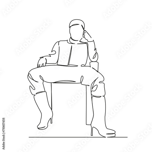 a man sits on a chair in women's boots