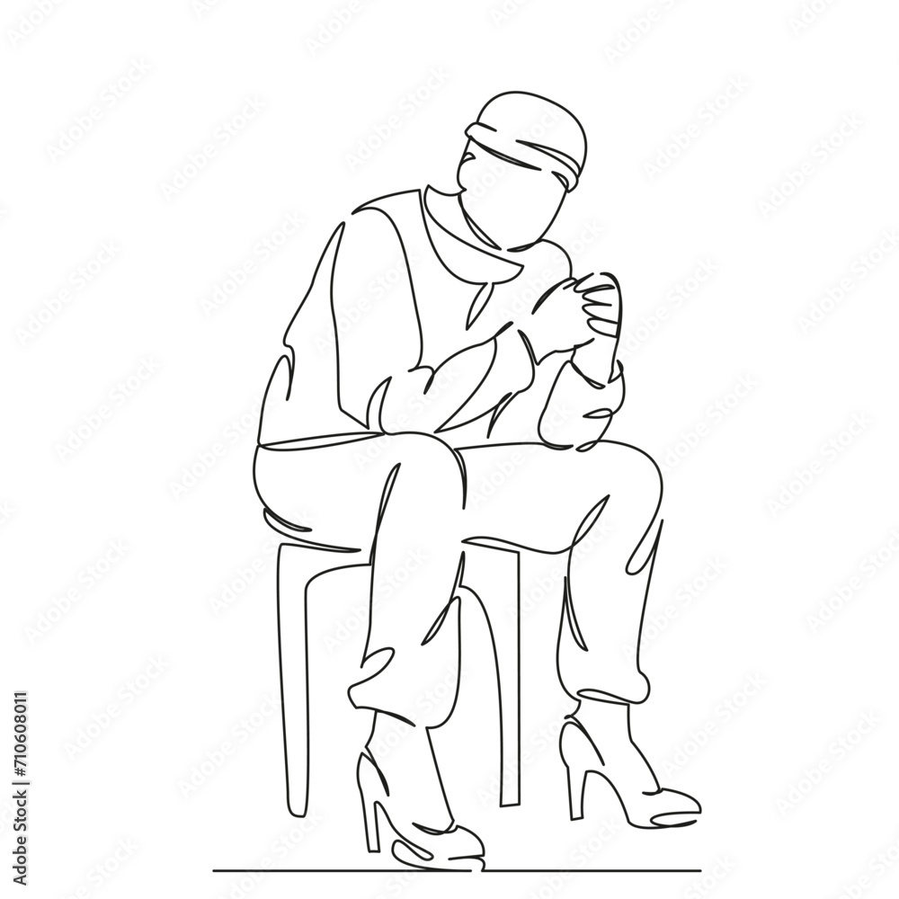 man sitting on a chair in women's shoes