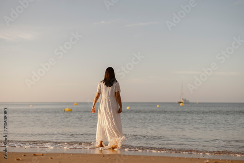 Luxury portrait of woman in white dress at the beach, Algarve, Portugal