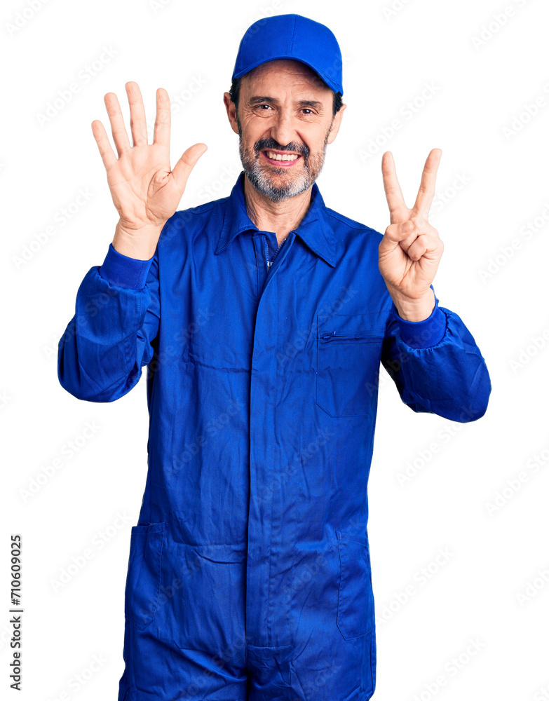 Middle age handsome man wearing mechanic uniform showing and pointing up with fingers number seven while smiling confident and happy.