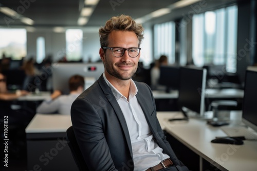 Nort American Man in an office dress on a suite, looking happy, CEO of a software company  photo