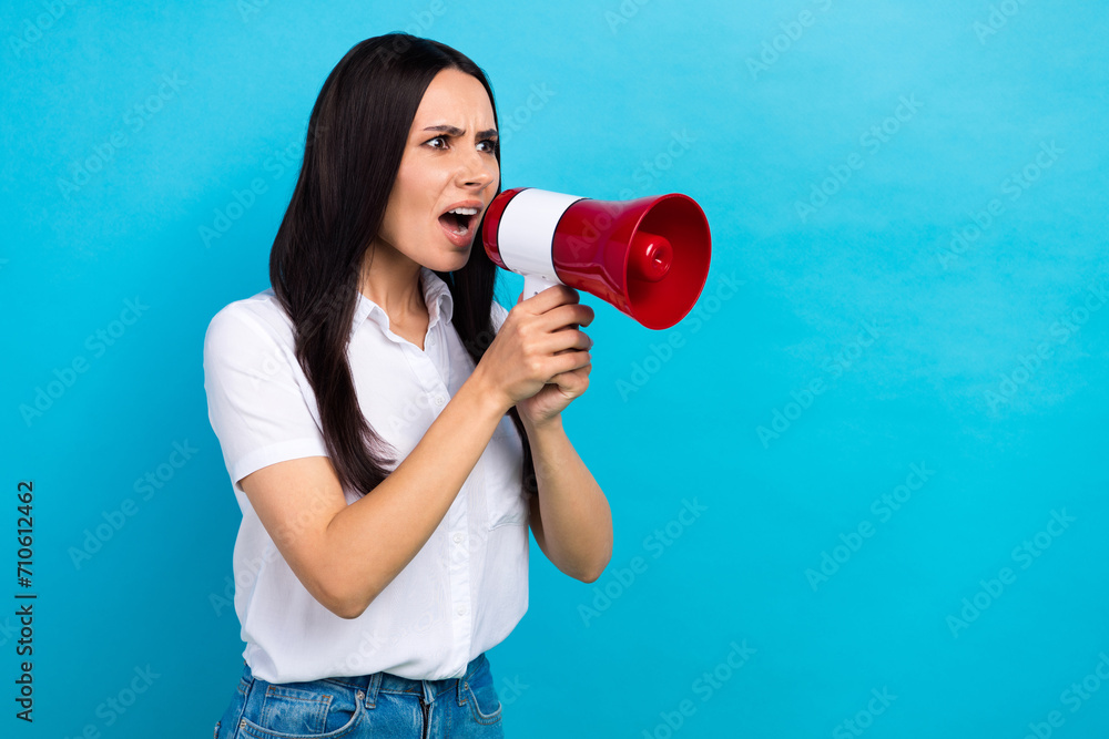Photo of angry impressed lady wear white shirt shouting loud speaker empty space isolated blue color background Photo of angry impressed lady wear white shirt shouting loud speaker empty space isolated blue color background