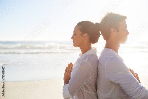 Yoga, meditation and space with couple on beach together for health, wellness or mindfulness in summer. Relax, peace or zen with young man and woman on sand by ocean or sea for awareness in nature #710618037