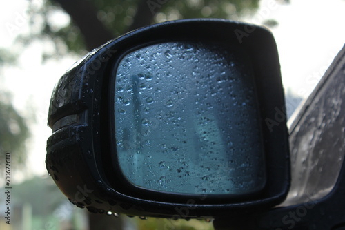 Car window rear view mirror in rainy