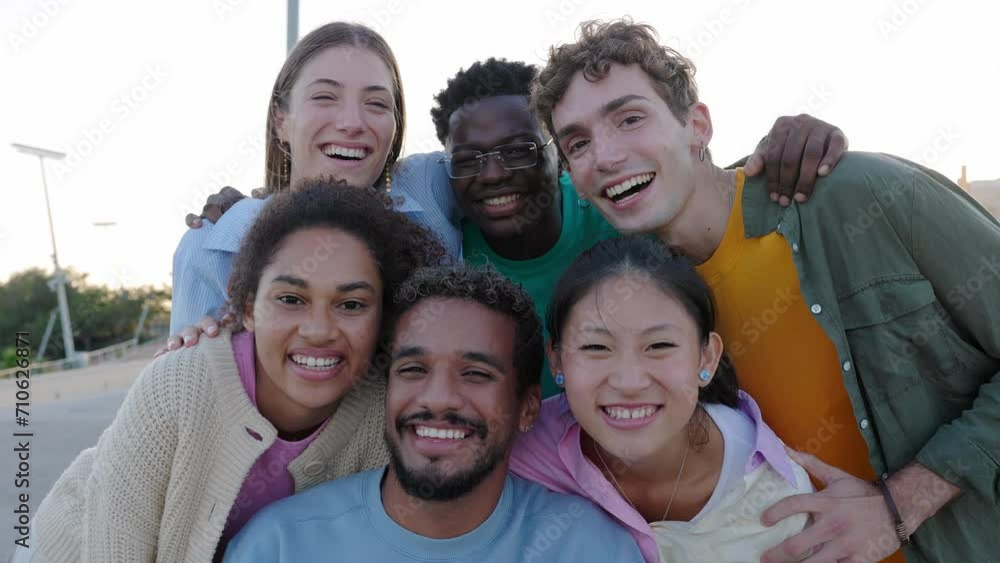 Portrait group of happy young gen z friends smiling at camera outdoor. Millennial diverse people relaxing together over urban background. Friendship and youth lifestyle concept. Portrait group of happy young gen z friends smiling at camera outdoor. Millennial diverse people relaxing together over urban background. Friendship and youth lifestyle concept.