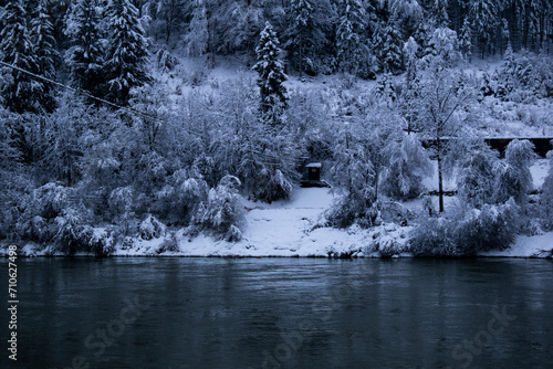 Bank of the Inn River with snow-covered trees